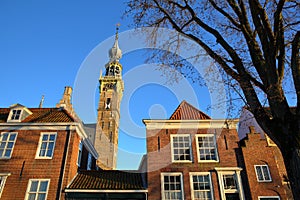 Traditional medieval houses and the Stadhuis town hall with its impressive clock tower in Veere