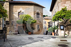 Traditional medieval square with citrus trees in Spanish village & x28;Poble Espanyol& x29; at Barcelona town, Catalonia, Spain