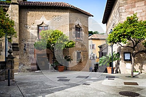 Traditional medieval square with citrus trees in Spanish village & x28;Poble Espanyol& x29; at Barcelona town, Catalonia, Spain photo