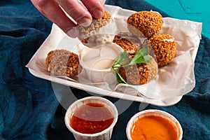 Traditional Mediterranean Arabic vegan falafel balls with a variety of dips