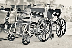 Traditional metallic wheel chairs in front of a hospital