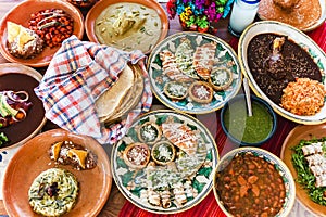 Traditional mexican dishes sopes, tacos dorados, tortillas, mole poblano, red rice, rajas poblanas, beans, pipian, salsa verde in