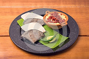 traditional Mexican food gourmet melted cheese with chistorra and corn tortillas on a plate