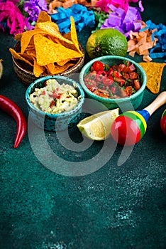 Traditional Mexican food nachos, salsa, guacamole, tequila.