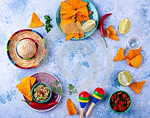 Traditional Mexican food nachos, salsa, guacamole, tequila.