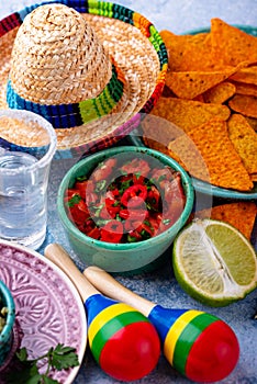 Traditional Mexican food nachos, salsa, guacamole, tequila.