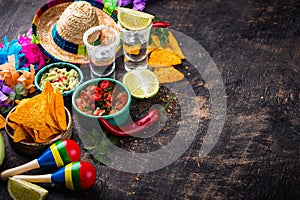 Traditional Mexican food nachos, salsa, guacamole, tequila.