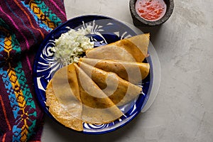 Mexican food. Steamed tacos also called de canasta on grey background photo