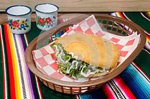 Traditional mexican gordita over a sarape