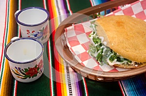 Traditional mexican gordita over a sarape