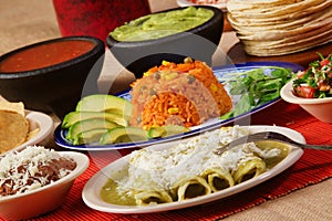 Traditional mexican green enchilada dinner