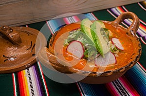 Traditional mexican pozole in clay dish