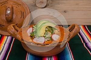 Traditional mexican pozole in clay dish