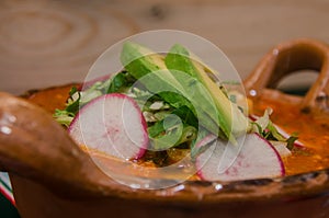 Traditional mexican pozole in clay dish