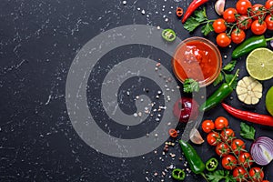 Traditional mexican salsa sauce and ingredients on dark stone background. Top view with copy space