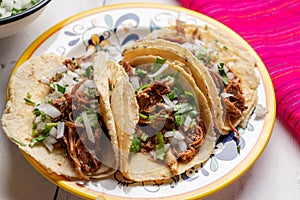 Mexican slow cooked lamb tacos also called barbacoa on white background photo