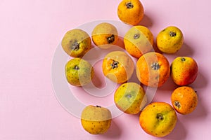 Mexican tejocote fruit on pink background photo