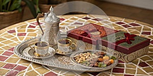 Traditional Middle Eastern coffee set with nuts and sweets on decorative table