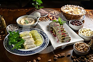 Traditional Middle Eastern food. Lebanese food. Arabian Stuffed Grape Leaves with Pomegranate seeds, Hummus, cabbage malfuf, raw