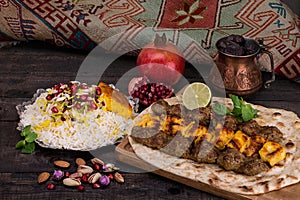 Traditional Middle eastern Persian chicken and lamb meat Shashlik Kebab skewered meat BBQ Grill on flat pita bread and saffron r