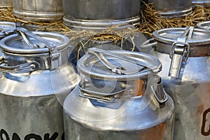 Traditional Milk Cans in front of a farm