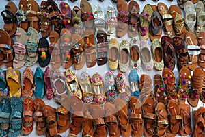 Traditional mojari shoes Juttis of various designs on display. These are shoes made from leather and decorated with various