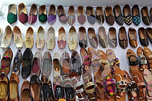 Traditional mojari shoes Juttis of various designs on display. These are shoes made from leather and decorated with various