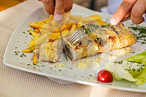 Traditional Montenegrin Meat Negush Steak on white plate in a restaurant