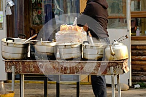 Traditional morning street food in China, using coal fire for heating soup. Perfect breakfast in winter
