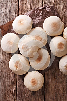 Traditional Moroccan batbout small bread close-up. vertical top