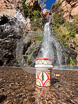 A traditional Moroccan cup of tea in the middle of a natural waterfall, Tezgi Waterfall, Taroudant Province