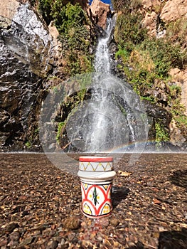 A traditional Moroccan cup of tea in the middle of a natural waterfall, Tezgi Waterfall, Taroudant Province