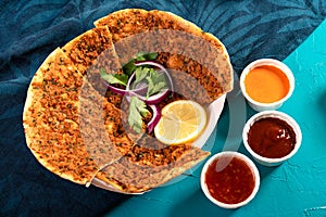 Traditional Moroccan pizza flatbread topped with red lentils and herbs served with dips