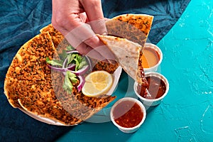 Traditional Moroccan pizza flatbread topped with red lentils and herbs served with dips