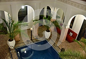 Traditional Moroccan riad interior with a pool photo