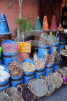 Traditional Moroccan shop - big blue containers with herbs, spice and small things in old city of Marrakech