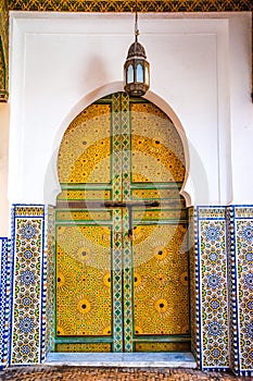 Traditional Moroccan style design of an ancient wooden entry door in the old Medina of Fez. Typical, old, intricately carved,
