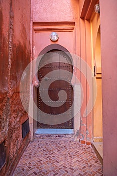 Traditional Moroccan style design of an ancient wooden entry door. In the old Medina in Marrakech, Morocco. Typical, old