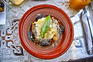 Traditional Moroccan tajin dish. This is meat and some vegatebles or fruits. This typical food is cooked in African ceramic