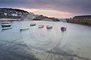 Traditional Mousehole Harbour landscape before sunrise on Cornwall coast in England