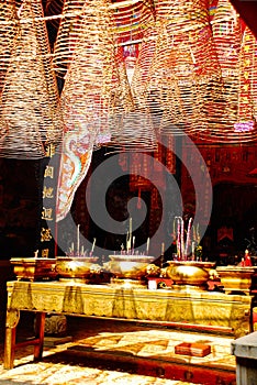 Traditional mystic budhist alter with the smoking candles and lamp