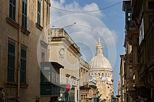 Traditional narrow street and church in Valletta in Malta