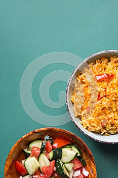 Traditional National Mexican Tomato Rice Stewed Pilaf with Hot Chili Peppers Garlic in Bowl. Fresh Cucumber Onion Salsa