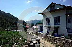 Traditional nepali houses and walking narrow street in Junbesi sherpa village photo