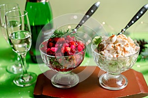 Traditional New Year and Christmas salad on holiday, on a plate, winter, New Year`s still-life with champagne and