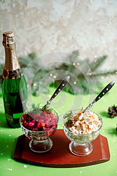 Traditional New Year and Christmas salad on holiday, on a plate, winter, New Year's still-life with champagne and candles, old