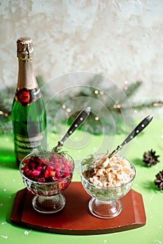 Traditional New Year and Christmas salad on holiday, on a plate, winter, New Year's still-life with champagne and candles, old