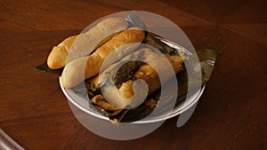 Nicaraguan dish of nacatamal accompanied by bread on a table. photo