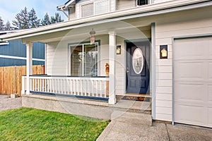 Traditional northwest home with navy blue door and white fencing