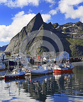 Traditional Norwegian fishing boats in Lofoten Island, Reine area with nice reflections in the ocean